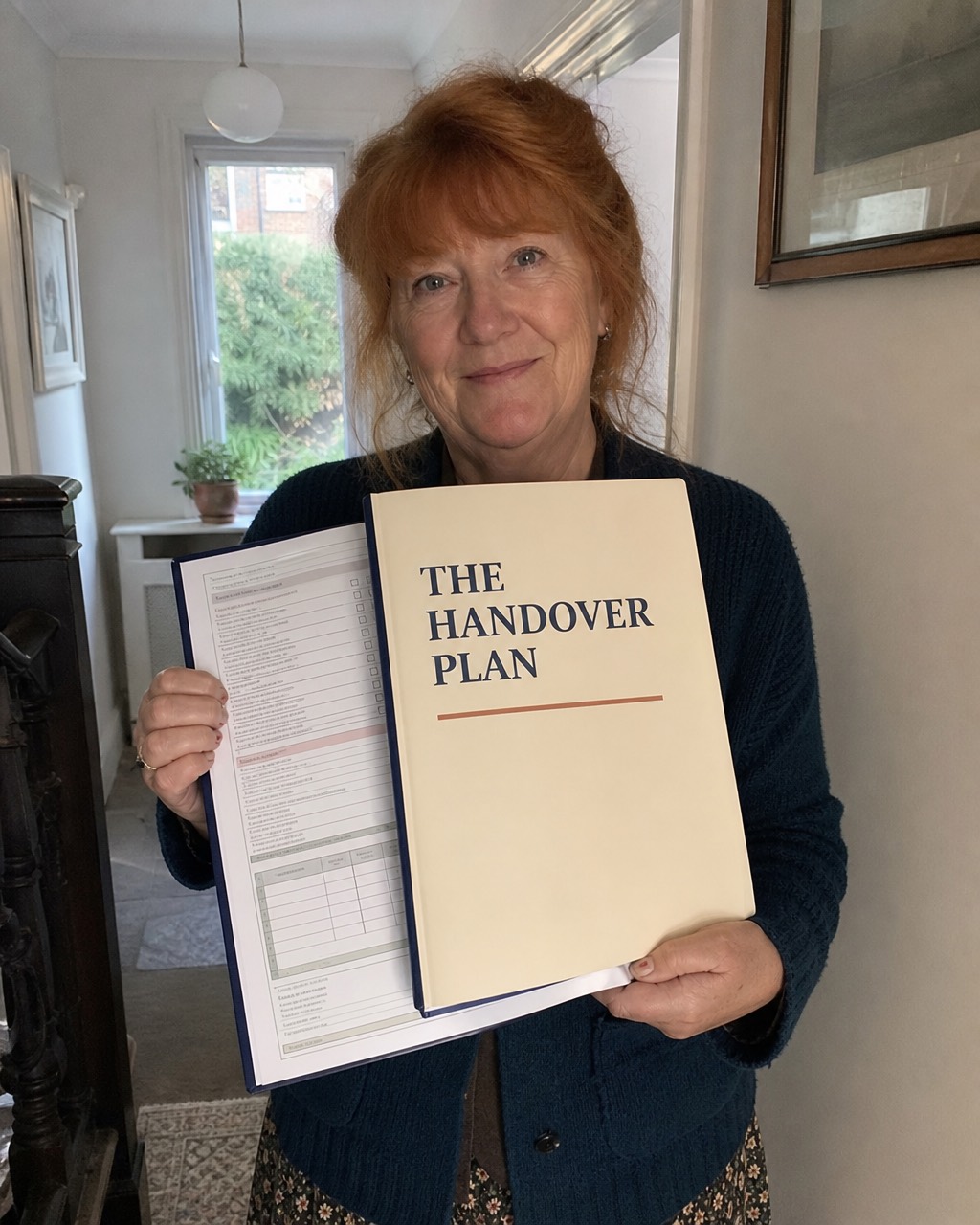 Christine F. holding her Handover Plan folder