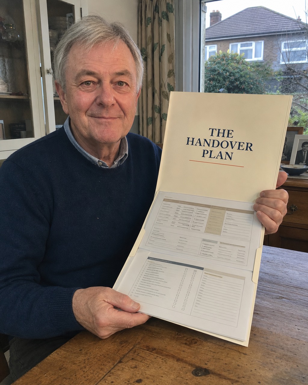 James B. at his table with his completed Handover Plan folder